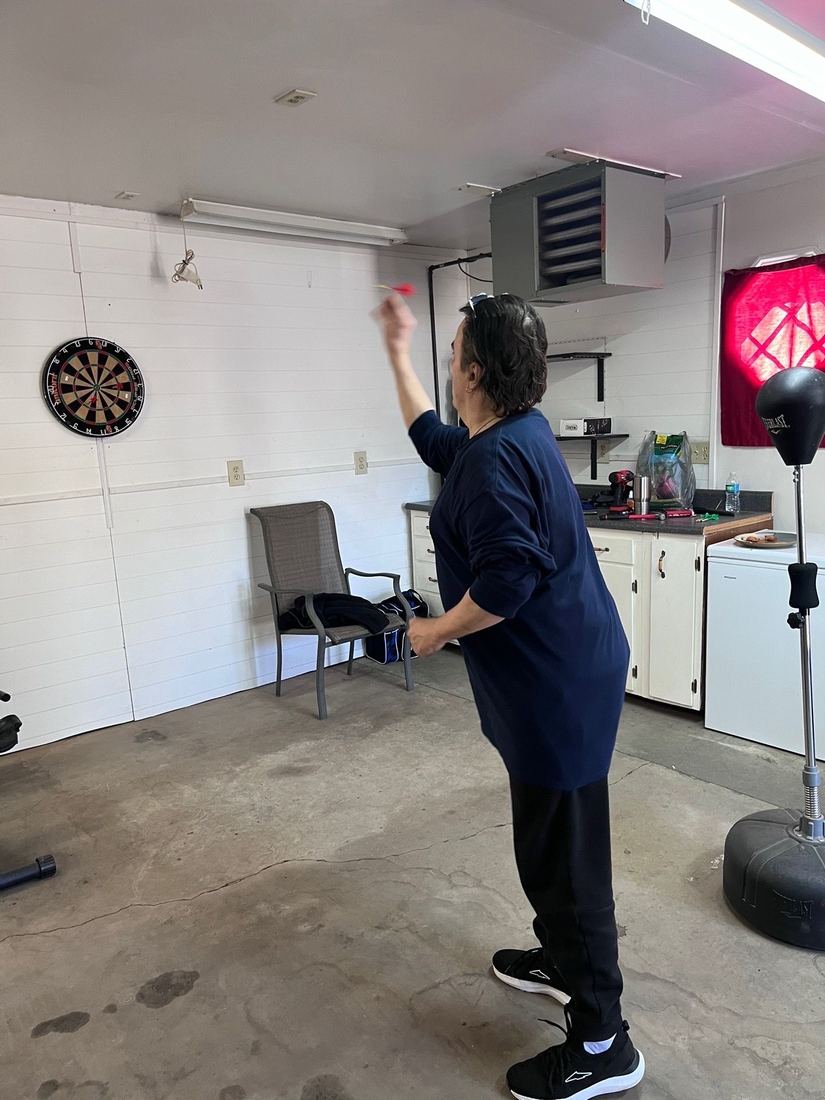 Resident playing in a dart tournament